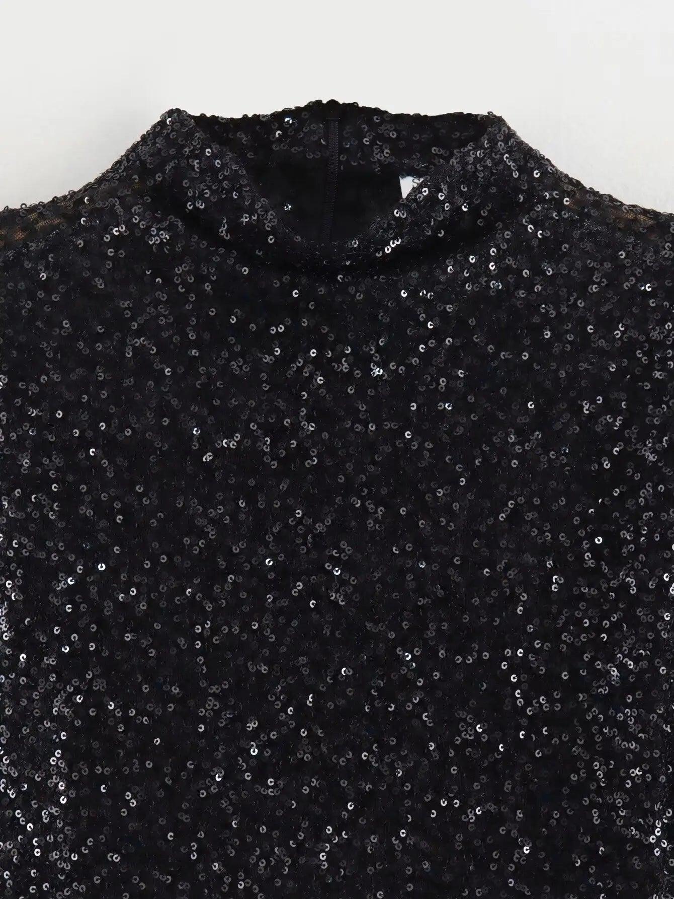 Black sequin embellished mini dress by Lumina Vancouver, featuring a fitted silhouette and stylish design.
