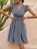 Black Rauha Nightingale wrap mini dress by Lumina Wear, featuring a stylish and elegant design perfect for casual or evening wear.