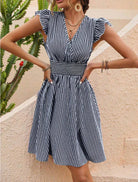 Black Rauha Nightingale wrap dress by Lumina Vancouver, stylish mini dress with a flattering fit and elegant design.