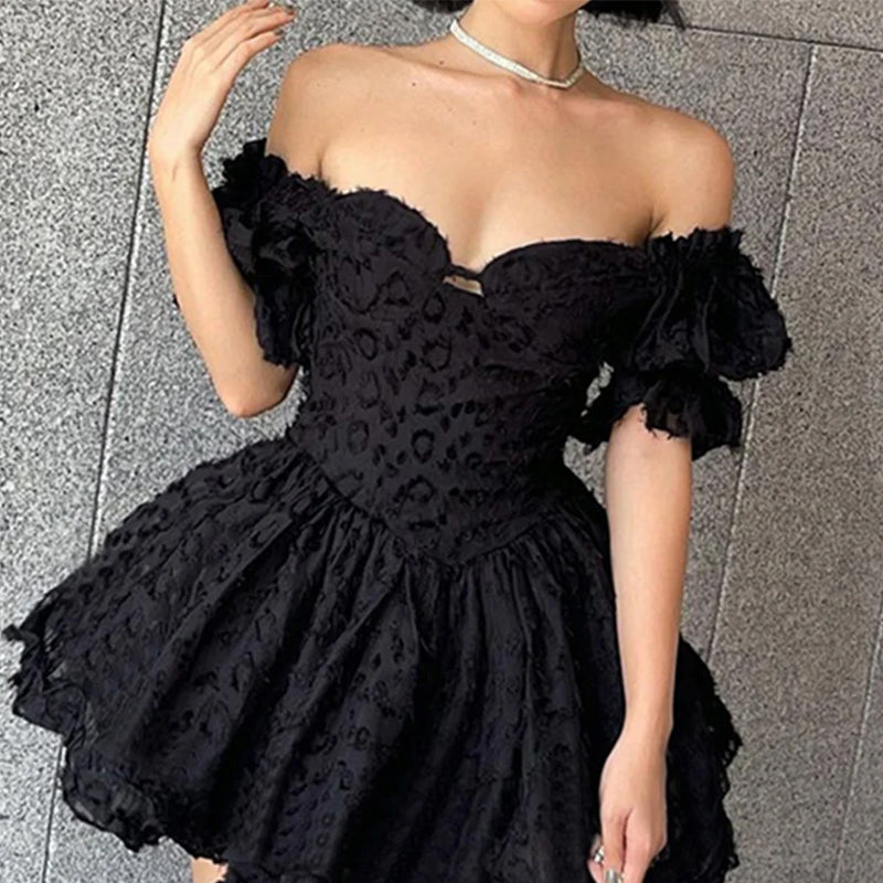 Black off-shoulder mini dress by Lumina Vancouver, featuring a fitted silhouette and elegant neckline, perfect for stylish occasions.