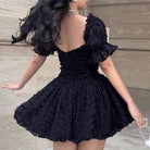 Black off-shoulder mini dress from Lumina Vancouver's Aino collection, featuring a stylish, fitted silhouette.