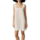 Black Celestina sleeveless mini dress by Lumina Vancouver, fitted style with a sleek, modern design, shown on a model.