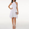 Black Lyra halter neck mini dress with layered skirt by Lumina Wear, showcased on a model standing in a stylish setting.