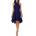Black Lyra halter neck mini dress by Lumina Wear with a layered skirt, shown on a model in a stylish outdoor setting.