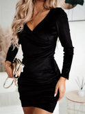 Black Nia velvet wrap mini dress with V-neck and long sleeves by Lumina Wear, showcased on a model.