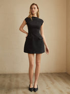 Black Serilda Belle Luxe A-line mini dress by Lumina Vancouver, shown on a model with elegant fit and stylish design.