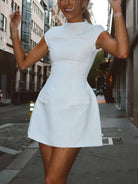 Black Serilda Belle Luxe A-line mini dress by Lumina Vancouver, shown on a model with stylish detailing and a fitted silhouette.