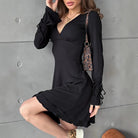 Black Gwyneth mini dress with flared sleeves and deep V-neck by Lumina Vancouver, shown on a model.