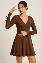 Black Gwyneth mini dress with flared sleeves and deep V-neck by Lumina Vancouver, shown on a model.