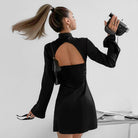Black satin Vesna mini dress by Lumina Vancouver, form-fitting with a sleek, elegant silhouette perfect for stylish occasions.