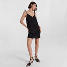 Black Carys satin slip dress by Lumina Vancouver, mini length with a smooth, shiny satin finish and delicate straps.
