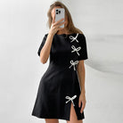 Black Seraphine Marigold A-line mini dress by Lumina Vancouver, showcasing a stylish and elegant silhouette.