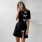 Black Seraphine Marigold A-line mini dress by Lumina Vancouver, featuring a stylish, fitted silhouette perfect for casual or semi-formal wear.
