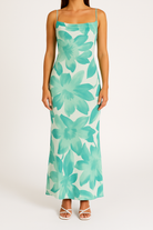 Green Magnolia Serenade bodycon mini dress by Lumina Vancouver, fitted design, sleeveless style, perfect for stylish occasions.