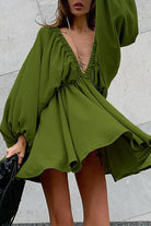 Green Camellia lantern-sleeve mini dress with a deep V-neck by Lumina Vancouver, featuring a stylish, fitted silhouette.