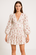 Pink Elara Rose Bloom Atelier A-Line Mini Dress by Lumina Wear, displayed on a hanger with floral patterns.