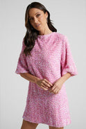 Pink Isolde mini dress by Lumina Wear with sequin embellishments and a plunging back, displayed on a mannequin.