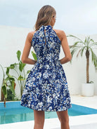 Pink floral halter neck mini dress by Lumina Vancouver with a fitted silhouette and delicate ruffle details.