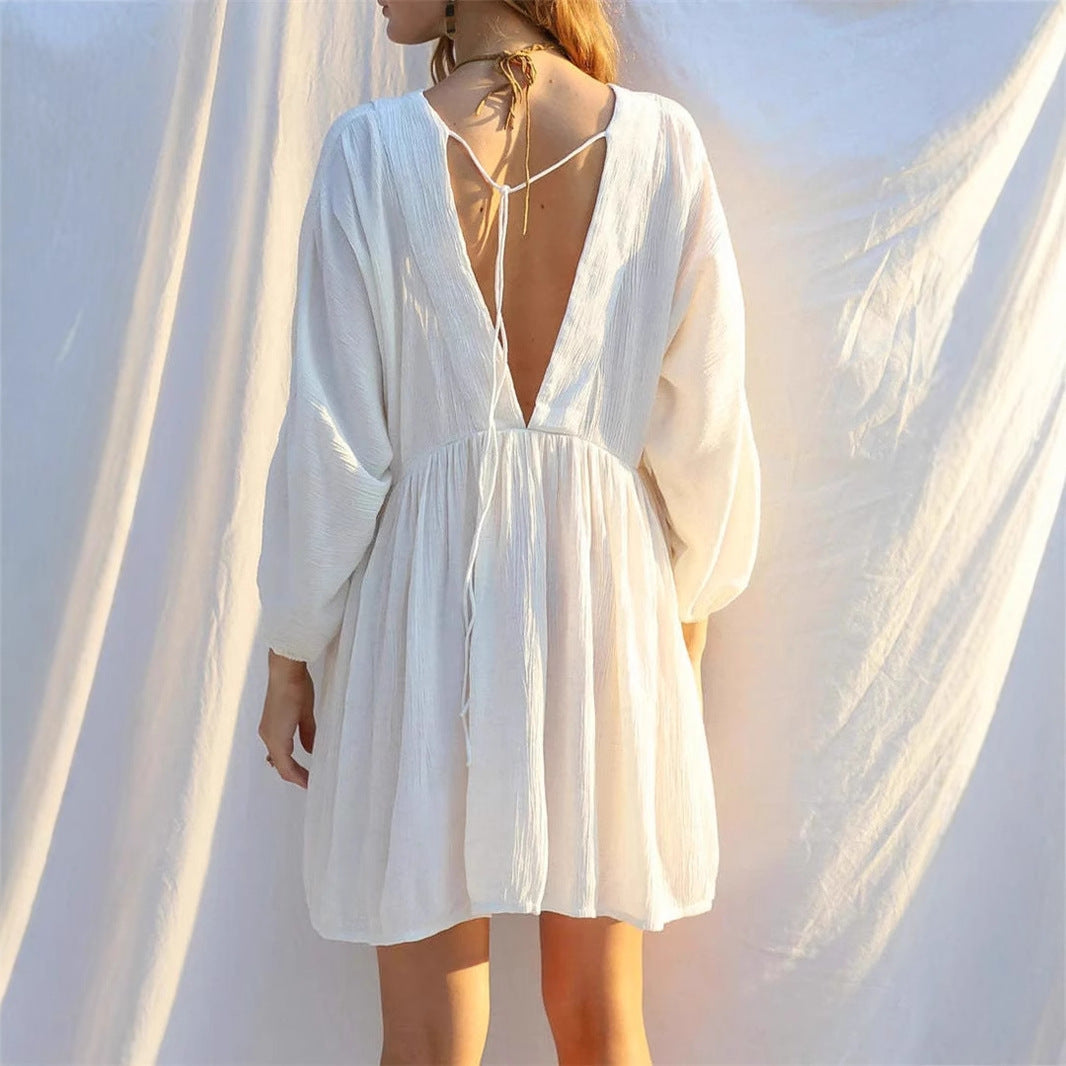 White Jacinta mini dress by Lumina Vancouver featuring a sheer V-neck and free-size fit, displayed on a mannequin.
