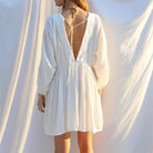 White Jacinta mini dress by Lumina Vancouver featuring a sheer V-neck and free-size fit, displayed on a mannequin.