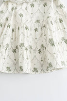 White and green Marin Willow wrap dress with V-neck, by Lumina Vancouver, featuring a stylish mini dress design.