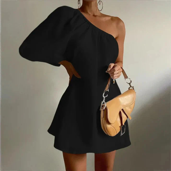 White Godeliève one-shoulder mini dress by Lumina Vancouver, elegant sleeveless design, perfect for chic summer occasions.