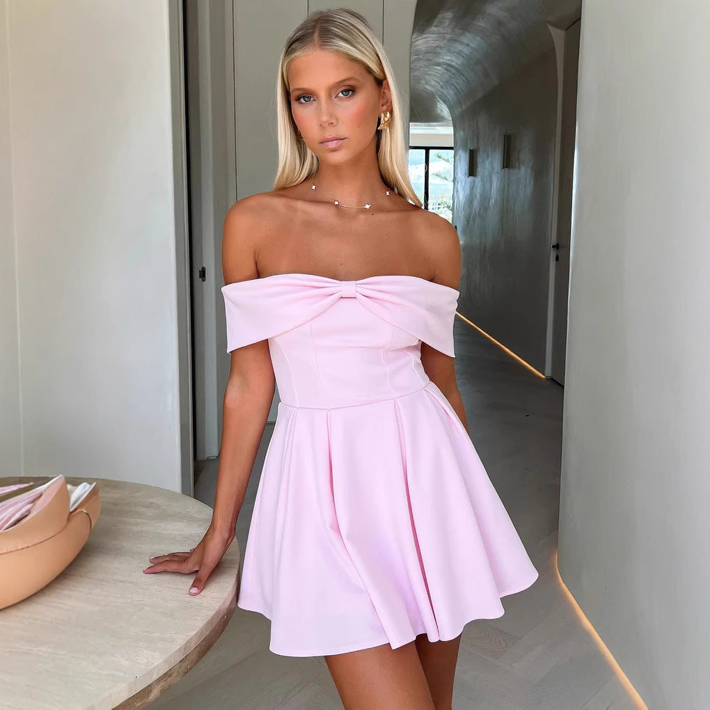 White Kari off-shoulder A-line mini dress by Lumina Vancouver styled on a model with flowing fabric and elegant design.