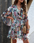 White women's floral V-neck mini dress by Lumina Vancouver featuring a relaxed fit and lightweight fabric.