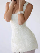White Lumina Vancouver Honoria mini dress with 3D floral textured fabric, showcasing a stylish and feminine design.