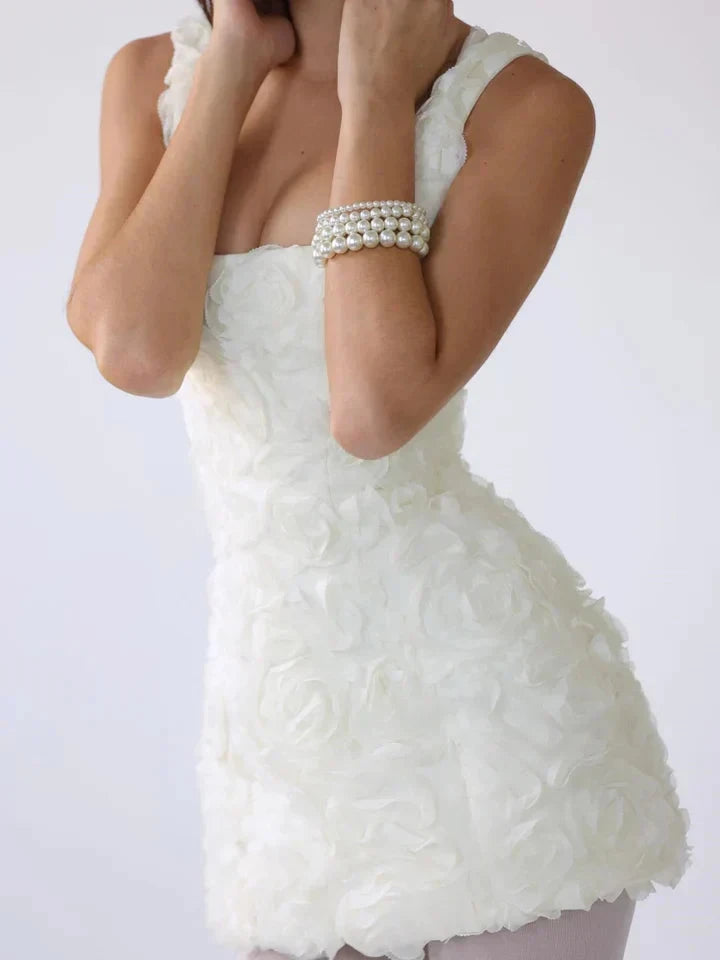 White Lumina Vancouver Honoria mini dress with 3D floral textured fabric, showcasing a stylish and feminine design.