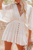 White women's romper with deep V-neck from Lumina Vancouver, featuring a stylish mini dress design and sleeveless fit.