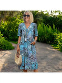 Red Isla Spring Dress by Lumina Wear, lightweight fabric and floral design, shown on a model.