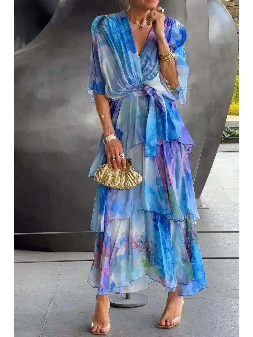 Lumina Vancouver Avalance chic elegant multi-color maxi dress displayed on a hanger, showcasing vibrant fabric and flowing design.