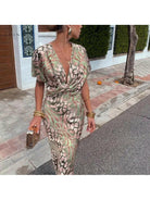Lumina Vancouver Roxane long dress with twist V-neck, flowing fabric, and elegant design perfect for formal occasions.