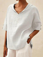 Blue women's casual V-neck shirt by Lumina Vancouver, displayed flat with soft fabric and relaxed fit.