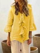 Blue women's casual cotton ruffle shirt with 3/4 sleeves from Lumina Vancouver, displayed on a hanger.
