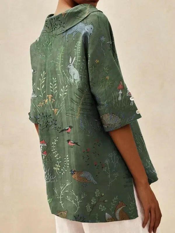 Women's casual V-neck shirt with woodland and animal print by Lumina Vancouver, featuring a green pattern and relaxed fit.