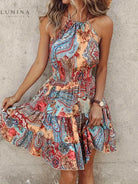 Tangerine red halter dress by Lumina Vancouver, featuring a stylish neckline and flowing fabric, perfect for summer or casual occasions.