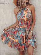 Bright tangerine red halter dress by Lumina Vancouver with a stylish silhouette, perfect for summer or special occasions.
