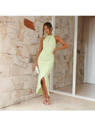 Green Brianna backless wedding guest dress by Lumina Vancouver, sleeveless with elegant backless design, perfect for formal occasions.