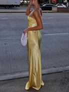 Lumina Vancouver Ursule suspender maxi dress, elegant wedding guest dress in flowing fabric with adjustable straps and a stylish silhouette.