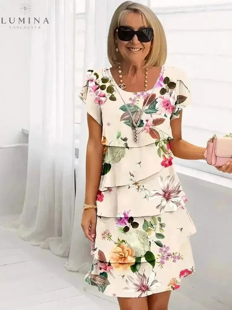 White Giselle floral dress by Lumina Vancouver, featuring a flowy design and vibrant floral pattern, perfect for spring and summer wear.