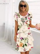 White Giselle floral dress by Lumina Vancouver, featuring a flowy design and vibrant floral pattern, perfect for spring and summer wear.