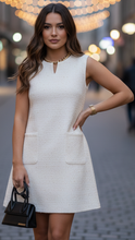 White Luna mini dress with buckle detail by Lumina Wear, fitted style, shown on model with a casual urban background.