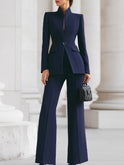 Navy blue Cassia set by Lumina Wear featuring a blazer and wide-leg trousers, displayed on a hanger against a white background.