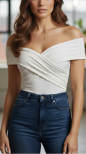 White sleeveless V-neck pleated blouse by Lumina Wear, showcasing a stylish and lightweight design perfect for casual or office wear.