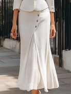 White textured peplum blazer and midi skirt set by Lumina Wear, styled together on a model in a fashion photo.