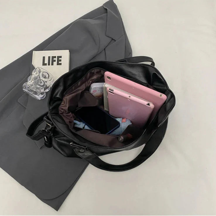 Lumina Wear Lunelle black handbag with spacious interior and versatile strap, made of sleek black material for stylish everyday use.