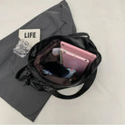 Lumina Wear Lunelle black handbag with spacious interior and versatile strap, made of sleek black material for stylish everyday use.