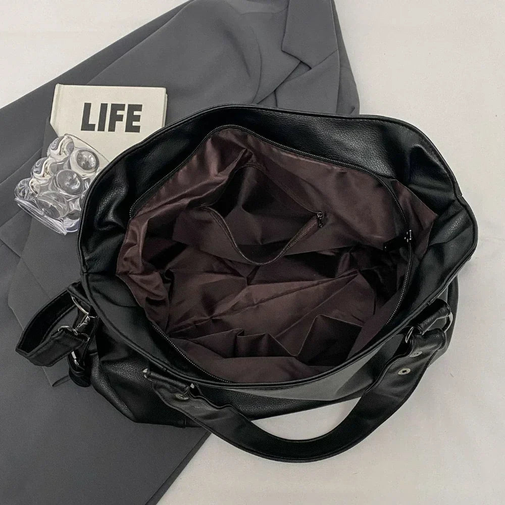 Lumina Wear Lunelle black handbag with spacious interior and versatile strap, shown with chocolate accents and stylish design.
